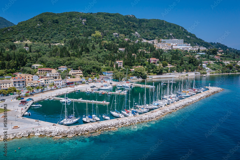Sailing boats in Benitses village on the Ionian Sea shore, Corfu Island, Greece