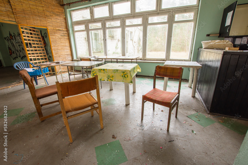 Old, dilapidated tables and coffee tables in an abandoned building. Urbex.