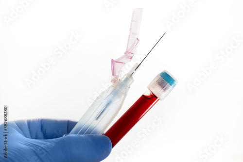 Technician with blood test and tube holder to analyze in the research lab. Doctor holding blood testing tube and adapter for extraction of samples isolated in white background for analysis diagnostic