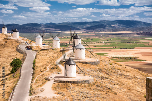 Series of windmill of Consuegra on the hill and in the background the plain of La Mancha (Spain) photo