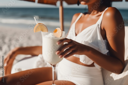 Beautiful black woman holding a pina collada cocktail while sitting in a sun lounger on the beach. Close-up of a hand holding a tropical drink. Photorealistic illustration generative AI. photo
