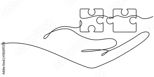 Hand holding two puzzles pieces continuous line drawn. Teamwork linear symbol. Vector illustration isolated on white.