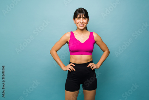 Young woman fitness coach looking happy exercising