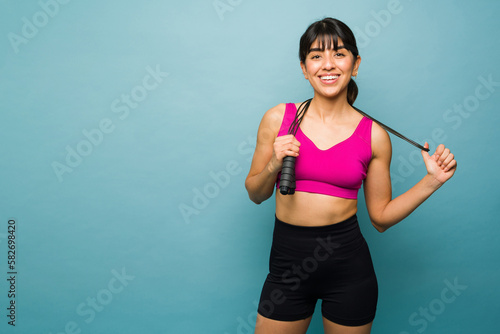 Beautiful fitness trainer working out with a jumping rope © AntonioDiaz