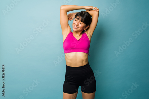 Happy fit woman warming up before working out