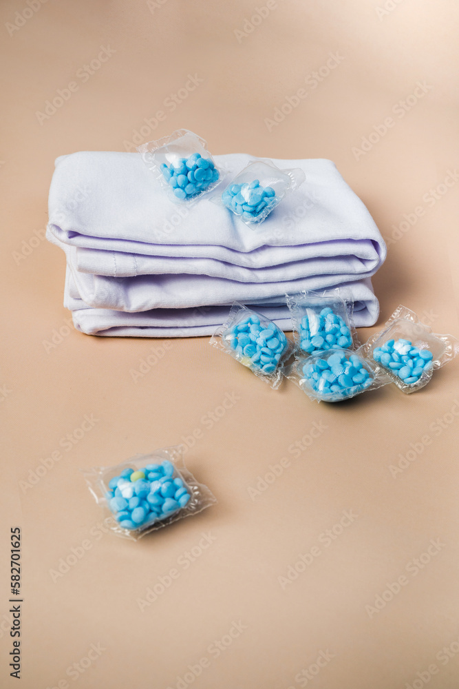 Capsules with Conditioner for colored linen. Close-up. Caps Powder for washing clothes