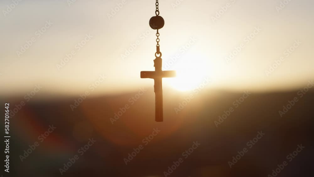Rosary crucifix at sunset light Rosary crucifix at sunset light