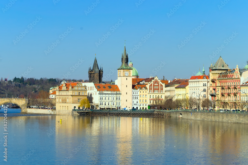 View of the embankment of the Vltava River in Prague, historical buildings, Charles Bridge