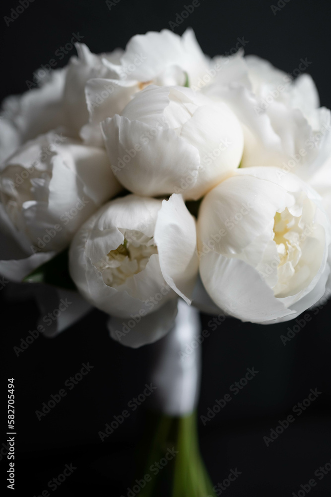 White peony wedding bouquet on darck background. White bridal bouquet. Wedding day. White peony wedding bouquet on darck background. White bridal bouquet. Wedding day.
