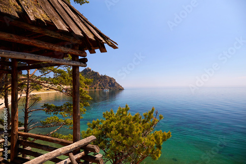 Wooden observation tower with a beautiful view of the bay with turquoise water. Picturesque landscape. © Viktoriya