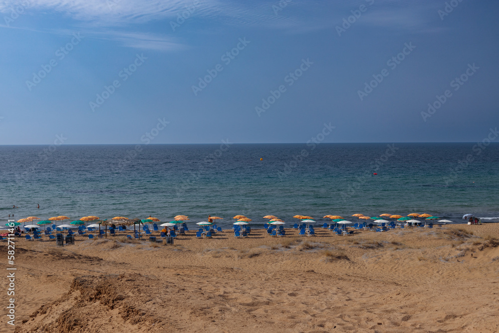 Corfu island's sandy beach, umbrellas and chairs. Corfu island's sandy beach, umbrellas and chairs.