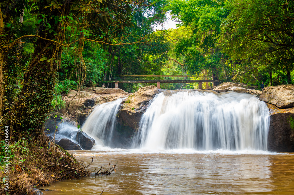 Mae sa waterfall near Chiang Mai city, Thailand. Flowing water in tropical rainforest.