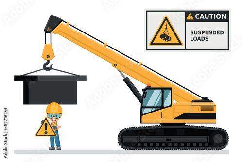 Telescopic crane on caterpillars. Warning Overhead load. Work accident. Worker with personal protective equipment. Industrial safety and occupational health at work