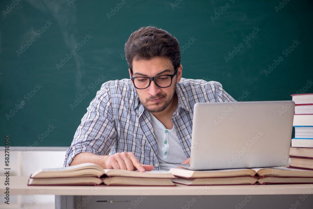 Young male student sitting in the classroom Young male student sitting in the classroom