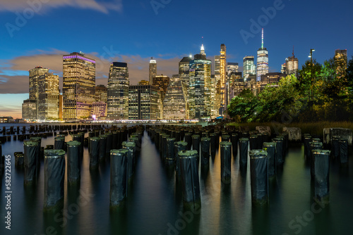 Beautiful Night Light and Lower Manhattan skyline with East River and New York City. Twilight with Reflections and Abandoned Pier © Mindaugas Dulinskas