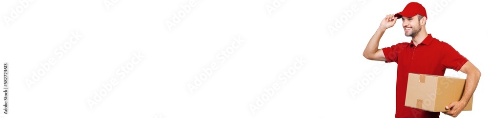 Happy delivery man carrying cardboard box on shoulder and smiling against white background Happy delivery man carrying cardboard box on shoulder and smiling against white background