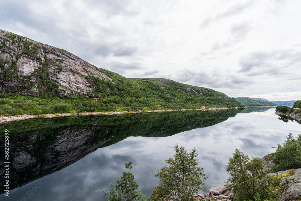 Norway Landscape with Lake and Reflection. Cloudy Blue Sky.