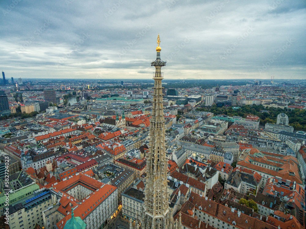 Fototapeta premium St. Stephen's Cathedral in Vienna, Austria. Roof and Cityscape in Background.