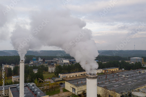Smoking chimneys on the late autumn sky background. Heating season. The view of chimneys tops of the thermal station. Vilnius, Lithuania