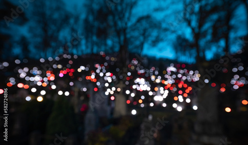 Catholic Cemetery Rasos in Vilnius, Lithuania. All Saints' Day November 1st. Blurry Candles Light Background.