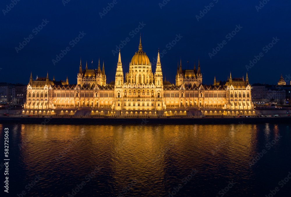 Budapest's Neo Gothic Landmark Hungarian Parliament Building and Danube River in Cityscape from a Drone Point of View. Night