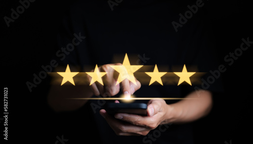 Customer review satisfaction feedback survey concept. User give rating to service excellent experience on mobile phone application, Client evaluate quality of service reputation ranking of business. photo