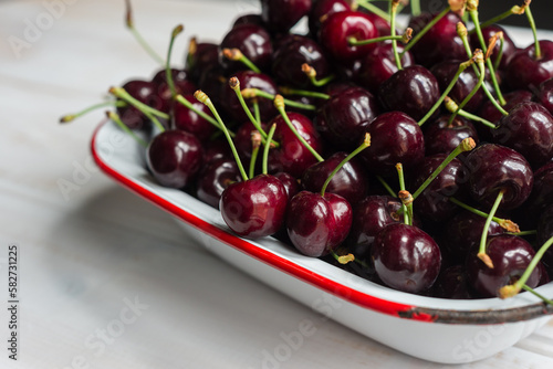 fresh juicy cherries in an old enamelware dish photo