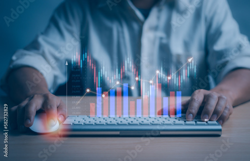investor or trader displays a virtual stock chart hologram for investment planning ,Finance and investing concepts, stock market, mutual funds, bonds, digital assets