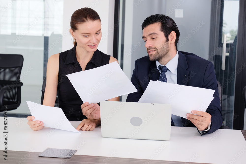 Office worker sitting on the desk using laptop and talking. Office worker sitting on the desk using laptop and talking.