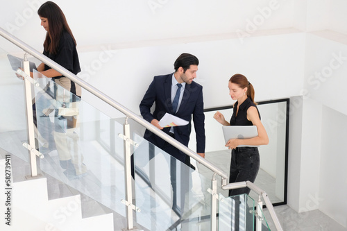 Managers and employees walking in the office.