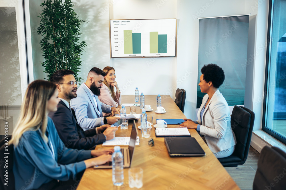 Group of businesspeople having a briefing in a boardroom. Businesspeople working together in a modern workplace. Group of businesspeople having a briefing in a boardroom. Businesspeople working together in a modern workplace.