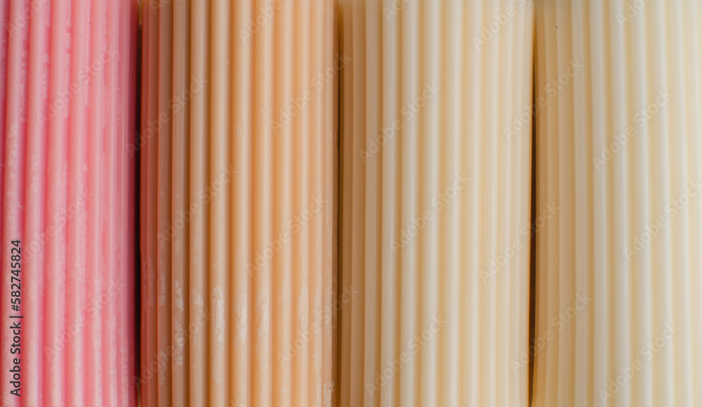 Obraz premium A cylindrical candle made of soy wax. Colour background