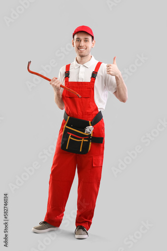 Male plumber with crowbar o...