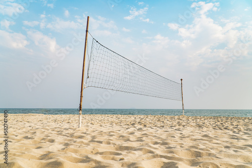empty volleyball net on the tropical beach with blue sky. beach sport.