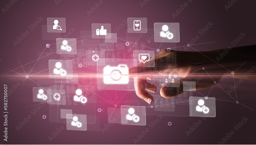 Hand pressing social media multimedia application screen with media icons on futuristic concept Hand pressing social media multimedia application screen with media icons on futuristic concept