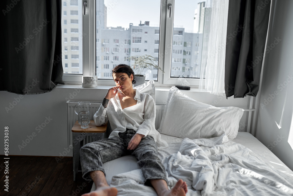 young handsome brunette smelling cigarette, looking at camera full leength shot.ree time, spare time, lifestyle.guy cannot stop smoking young handsome brunette smelling cigarette, looking at camera full leength shot.ree time, spare time, lifestyle.guy cannot stop smoking