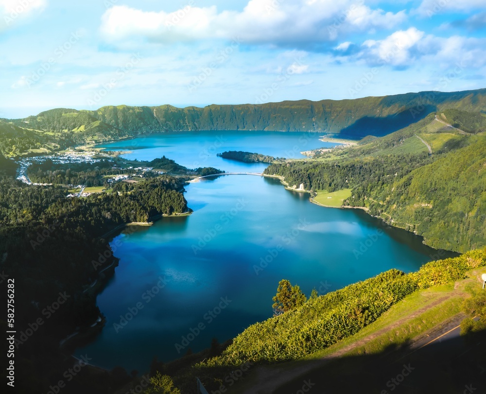 Aerial landscape of lake between green hills on a sunny day Aerial landscape of lake between green hills on a sunny day