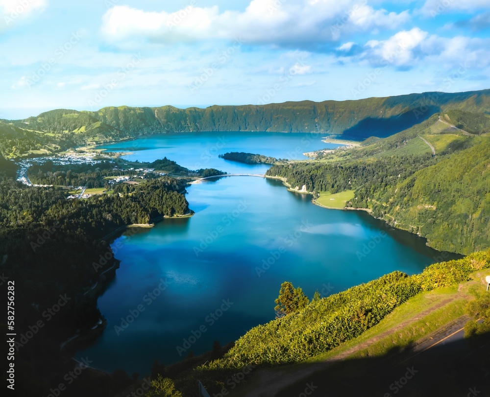 Aerial landscape of lake between green hills on a sunny day