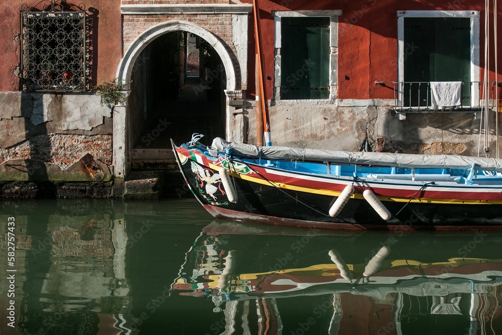 Old sailing boat in front of a historical building