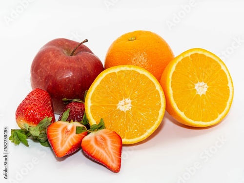 Delicious fresh juicy whole and halved fruits isolated on white background