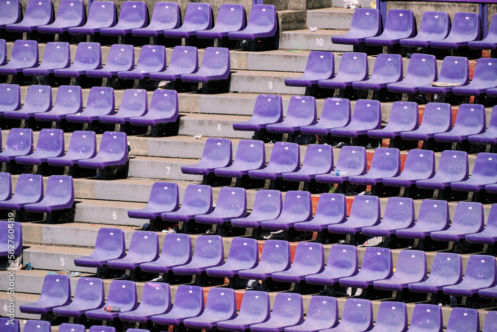 Stands of a stadium with garbage. After the game, the fans' footprint