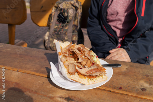 Canvas Print A doner kebab on a wooden table outdoors