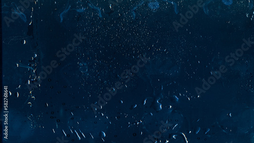 Wet glass. Distressed overlay. Weathered window. Rain water drops dust scratches noise on dark blue worn texture abstract illustration background.