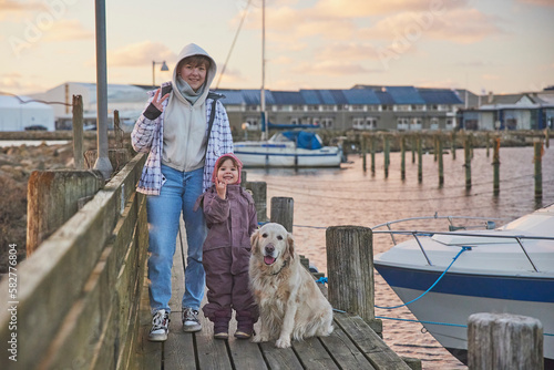 Children walking with a dog on the pier in the evening in Denmark