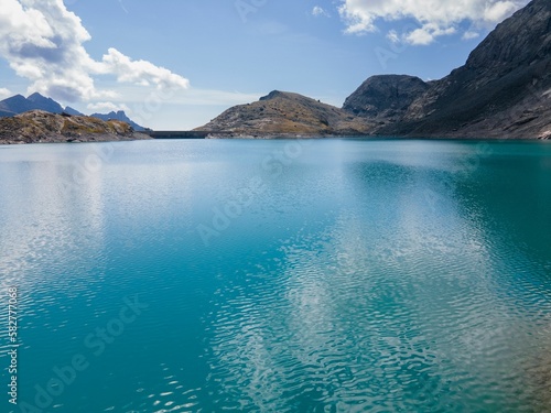 Aerial view of rocky mountains surrounded by lake in Usseglio photo