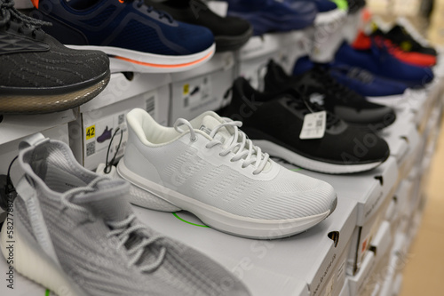 Boxes with men's shoes, sneakers in a shopping center in the sporting goods department, close-up. The concept of male shopping, trade, sale.
