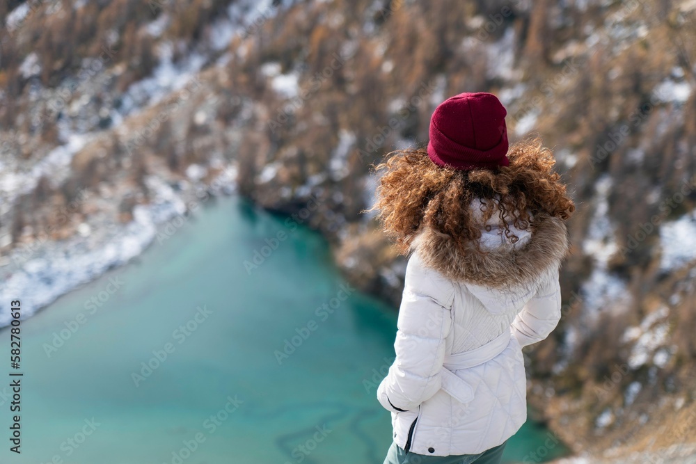 Overhead shot of a female looking at the Lago Blue lake in Ayas Valley, Monte Rosa mountain, Italy Overhead shot of a female looking at the Lago Blue lake in Ayas Valley, Monte Rosa mountain, Italy