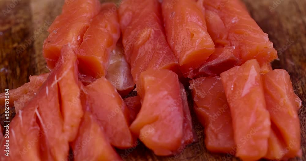 Sliced red trout meat with sea salt, medium-salted pickled red meat from trout and salmon