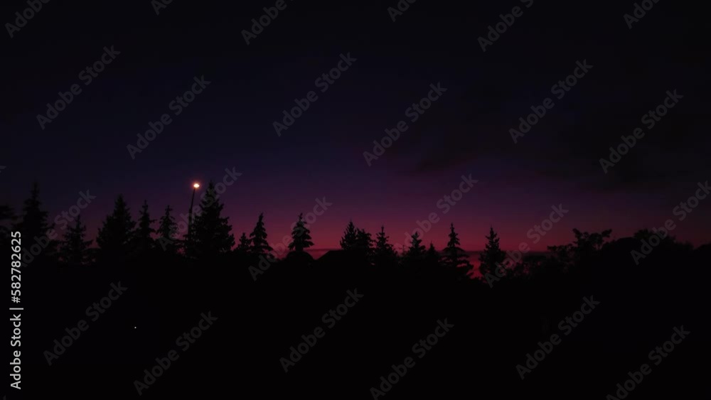 Mesmerizing sunset sky over a forest with silhouetted trees Mesmerizing sunset sky over a forest with silhouetted trees