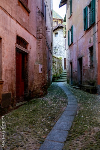 Vertical shot of a narrow alley between buildings in Argegno Italy